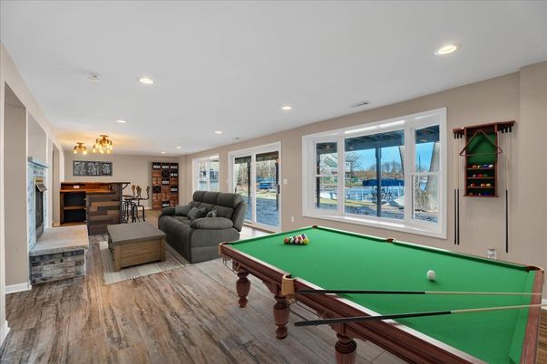 Billiard Table, Fireplace, Game Room, Interior, Recessed Lighting, Water, Wood Texture Flooring