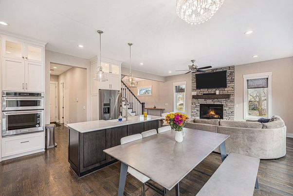 Chandelier, Dining room, Fireplace, Interior, Kitchen, Living room, Pendant Lights, Recessed Lighting, Stainless Steel Appliances, Wood Texture Flooring
