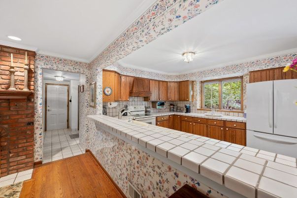 Interior, Kitchen, Recessed Lighting, Tile Countertops, Wood Texture Flooring
