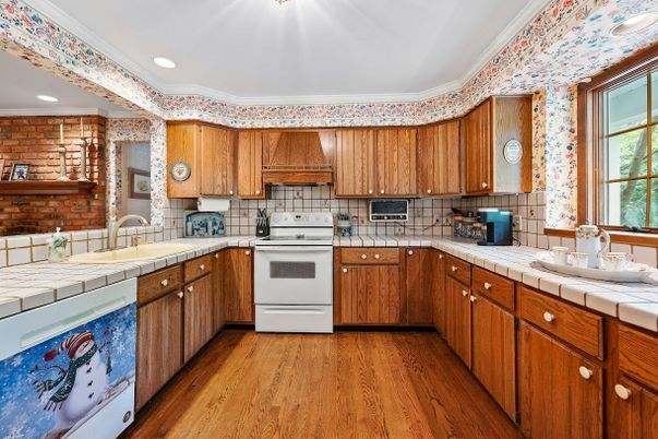 Interior, Kitchen, Recessed Lighting, Tile Countertops, Wood Texture Flooring