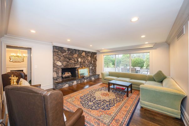 Chandelier, Fireplace, Interior, Living room, Recessed Lighting, Stone Walls, Wood Texture Flooring