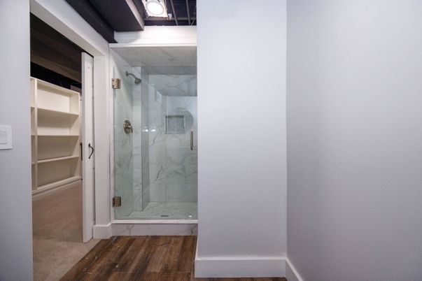 Bathroom, Glass Shower, Interior, Marble Walls, Wood Texture Flooring