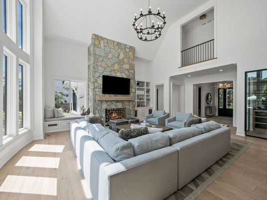 Chandelier, Fireplace, Interior, Living room, Pendant Lights, Recessed Lighting, Stone Walls, Wood Texture Flooring