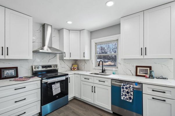 Interior, Kitchen, Marble Walls, Recessed Lighting, Stainless Steel Appliances, Wood Texture Flooring