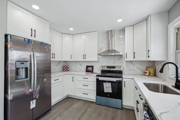 Interior, Kitchen, Marble Walls, Recessed Lighting, Stainless Steel Appliances, Wood Texture Flooring