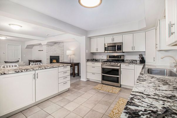 Fireplace, Interior, Kitchen, Recessed Lighting, Stainless Steel Appliances, Stone Walls
