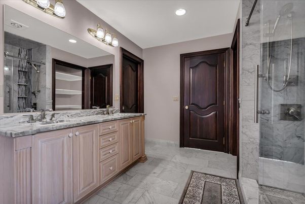 Bathroom, Dual Sink Vanities, Glass Shower, Interior, Marble, Marble Walls, Recessed Lighting, Walk-in Closets