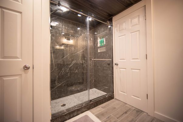 Bathroom, Glass Shower, Interior, Marble Walls, Wood Texture Flooring