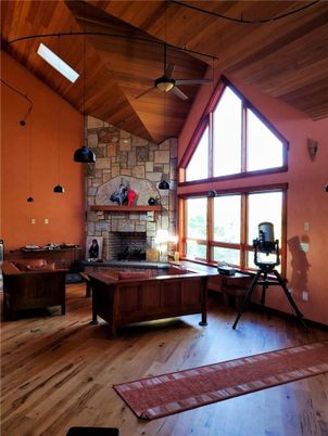 Billiard Table, Fireplace, Game Room, Interior, Living room, Pendant Lights, Stone Walls, Wooden Ceilings, Wood Texture Flooring
