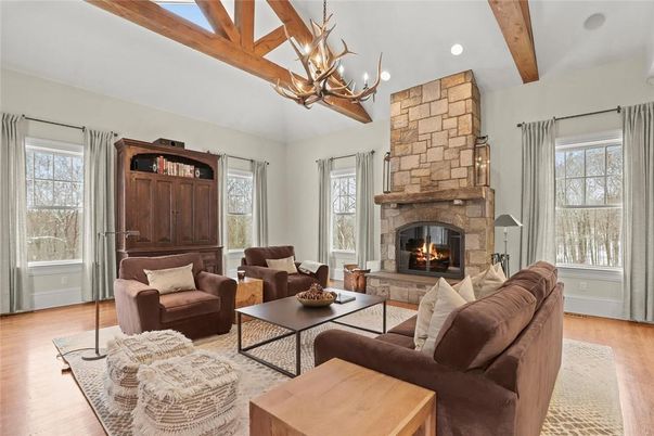 Chandelier, Fireplace, Interior, Living room, Recessed Lighting, Stone Walls, Wooden Beams, Wood Texture Flooring
