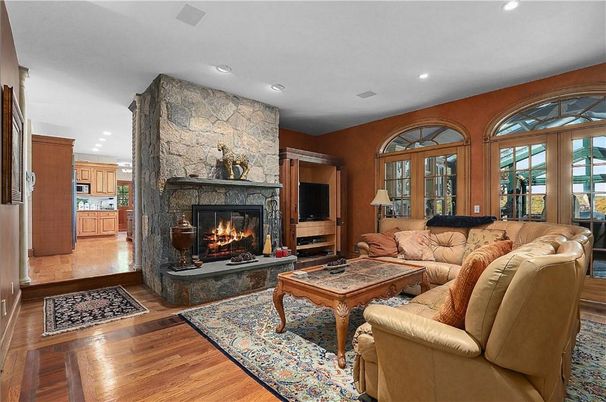 Fireplace, Interior, Living room, Recessed Lighting, Stone Walls, Wood Texture Flooring