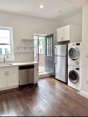 Interior, Kitchen, Recessed Lighting, Washer, Wood Texture Flooring