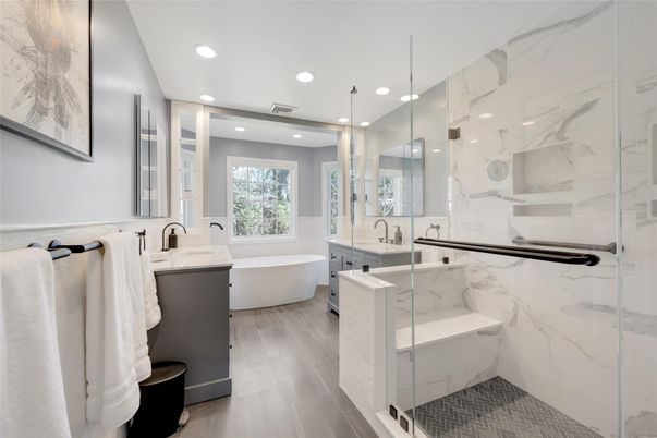 Bathroom, Dual Sink Vanities, Free Standing Baths, Glass Shower, Interior, Marble Walls, Recessed Lighting, Wood Texture Flooring