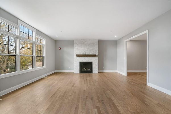 Empty room, Fireplace, Interior, Recessed Lighting, Stone Walls, Wood Texture Flooring
