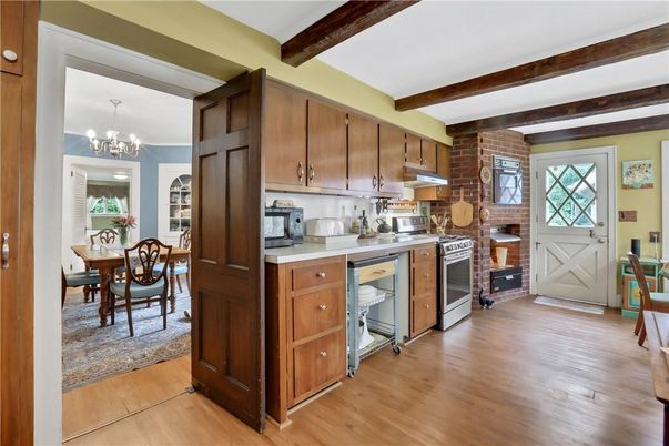 Chandelier, Dining room, Fireplace, Interior, Kitchen, Stone Walls, Wooden Beams, Wood Texture Flooring