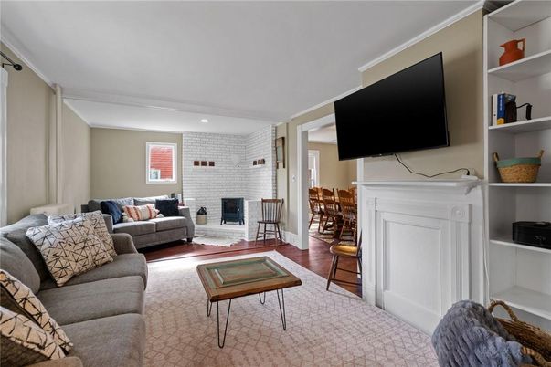 Dining room, Fireplace, Interior, Living room, Recessed Lighting, Stone Walls, Wood Texture Flooring