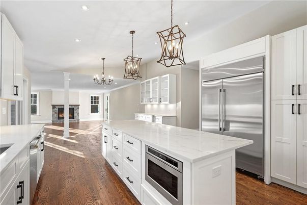 Chandelier, Fireplace, Interior, Kitchen, Pendant Lights, Recessed Lighting, Stainless Steel Appliances, Wood Texture Flooring