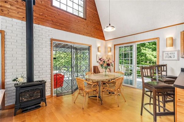 Dining room, Fireplace, Interior, Pendant Lights, Stone Walls, Wood Texture Flooring, Wooden Walls