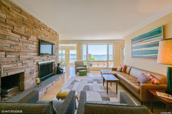 Fireplace, Interior, Living room, Recessed Lighting, Stone Walls, Water, Wood Texture Flooring