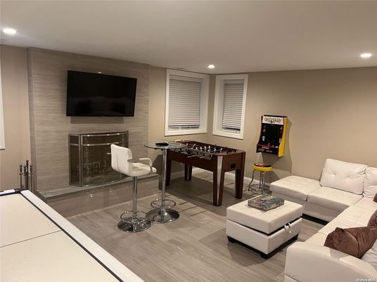 Fireplace, Game Room, Interior, Living room, Recessed Lighting, Wood Texture Flooring