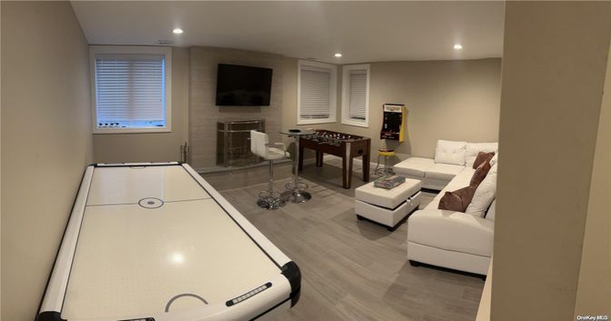 Fireplace, Game Room, Interior, Recessed Lighting, Wood Texture Flooring