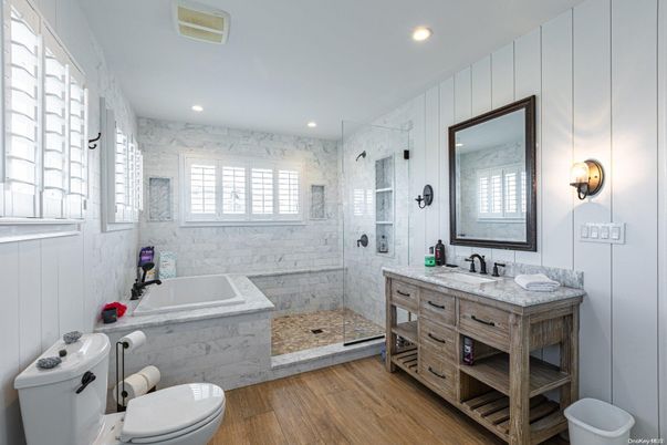 Bathroom, Dual Sink Vanities, Glass Shower, Interior, Marble Walls, Recessed Lighting, Wood Texture Flooring