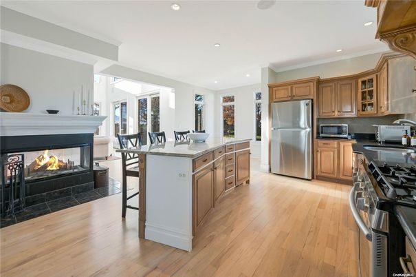Dining room, Fireplace, Interior, Kitchen, Recessed Lighting, Stainless Steel Appliances, Wood Texture Flooring