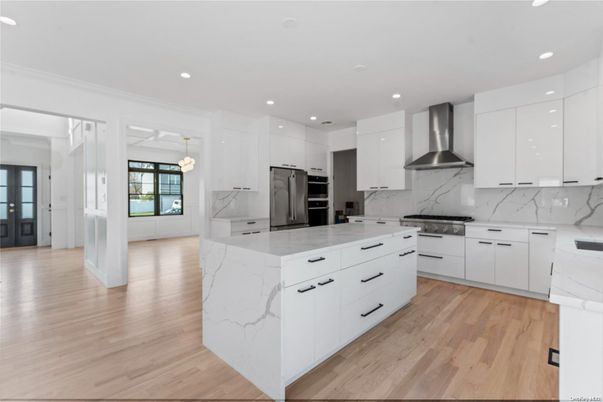 Interior, Kitchen, Marble Walls, Pendant Lights, Recessed Lighting, Stainless Steel Appliances, Wood Texture Flooring