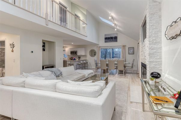 Dining room, Fireplace, Interior, Kitchen, Living room, Recessed Lighting, Stone Walls, Wood Texture Flooring