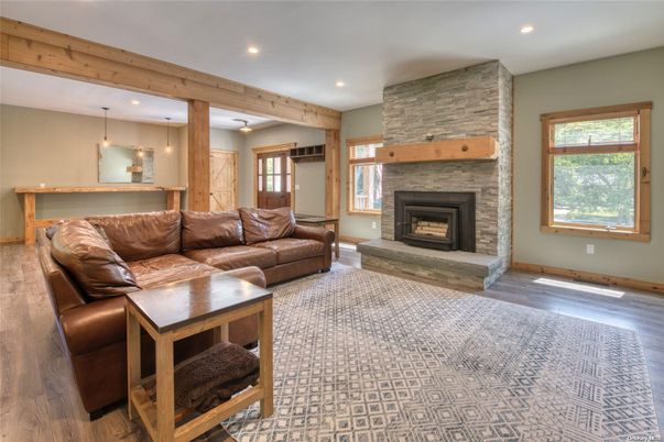 Fireplace, Interior, Living room, Pendant Lights, Recessed Lighting, Stone Walls, Wooden Beams, Wood Texture Flooring