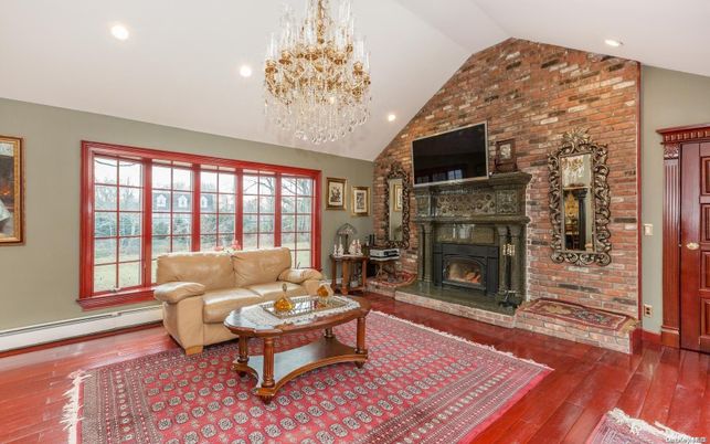 Chandelier, Fireplace, Interior, Living room, Recessed Lighting, Stone Walls, Wood Texture Flooring