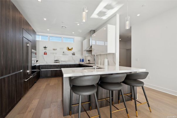 Interior, Kitchen, Marble Walls, Pendant Lights, Recessed Lighting, Stainless Steel Appliances, Wood Texture Flooring
