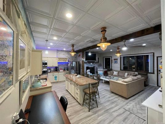 Fireplace, Interior, Kitchen, Living room, Pendant Lights, Recessed Lighting, Stainless Steel Appliances, Stone Walls, Wood Texture Flooring