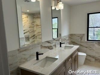 Bathroom, Dual Sink Vanities, Glass Shower, Interior, Marble Walls, Recessed Lighting