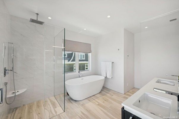 Bathroom, Free Standing Baths, Glass Shower, Interior, Marble Walls, Recessed Lighting, Wood Texture Flooring