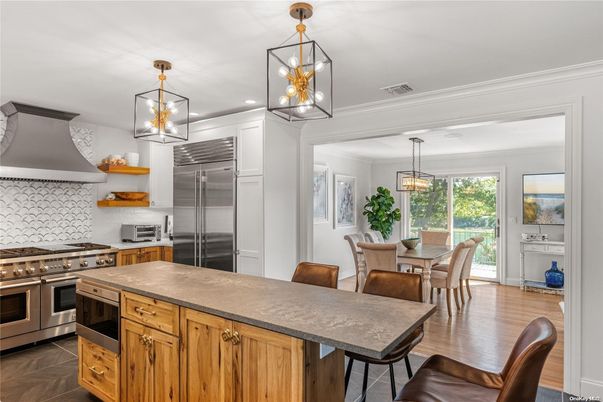 Chandelier, Dining room, Interior, Kitchen, Pendant Lights, Recessed Lighting, Stainless Steel Appliances, Wood Texture Flooring