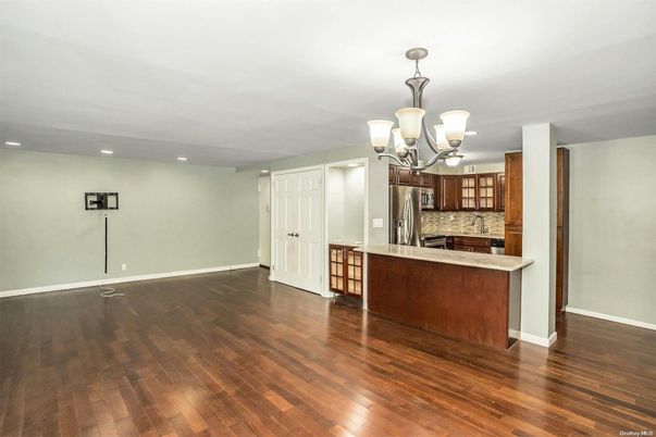 Chandelier, Empty room, Interior, Kitchen, Recessed Lighting, Stainless Steel Appliances, Wood Texture Flooring