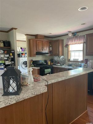 Interior, Kitchen, Recessed Lighting, Washer, Wood Texture Flooring