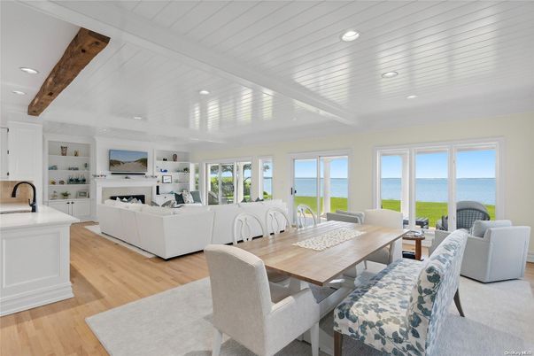 Dining room, Fireplace, Interior, Living room, Recessed Lighting, Water, Wooden Beams, Wood Texture Flooring