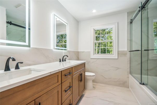 Bathroom, Dual Sink Vanities, Glass Shower, Interior, Marble, Marble Walls, Recessed Lighting