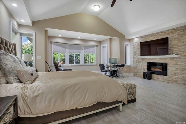 Bedroom, Fireplace, Interior, Recessed Lighting, Stone Walls, Wood Texture Flooring