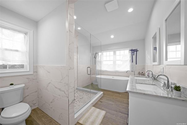 Bathroom, Free Standing Baths, Glass Shower, Interior, Marble Walls, Recessed Lighting, Wood Texture Flooring