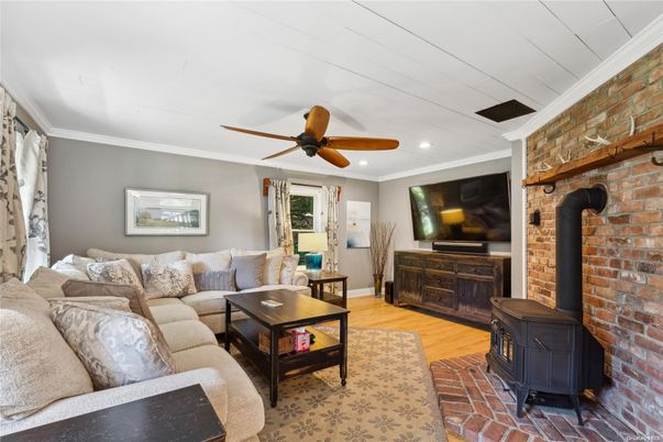 Fireplace, Interior, Living room, Recessed Lighting, Stone Walls, Wood Texture Flooring