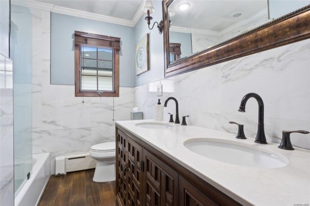Bathroom, Dual Sink Vanities, Glass Shower, Interior, Marble Walls, Wood Texture Flooring