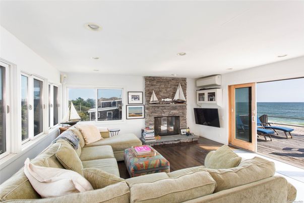 Fireplace, Interior, Living room, Recessed Lighting, Stone Walls, Water, Wood Texture Flooring