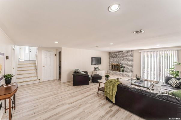 Fireplace, Interior, Living room, Recessed Lighting, Stone Walls, Wood Texture Flooring