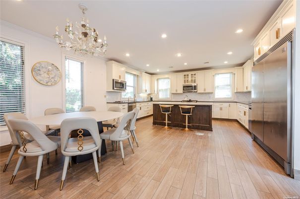 Chandelier, Dining room, Interior, Kitchen, Recessed Lighting, Stainless Steel Appliances, Wood Texture Flooring