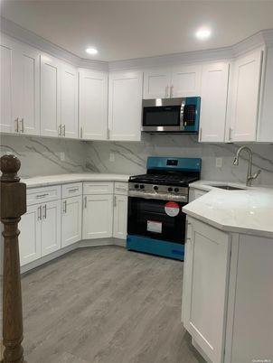 Interior, Kitchen, Marble Walls, Recessed Lighting, Stainless Steel Appliances, Wood Texture Flooring