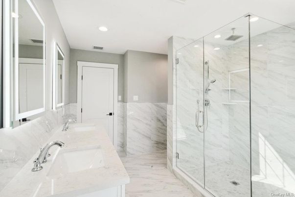 Bathroom, Dual Sink Vanities, Glass Shower, Interior, Marble, Marble Walls, Recessed Lighting