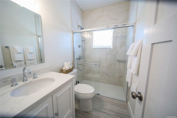 Bathroom, Glass Shower, Interior, Marble Walls, Wood Texture Flooring